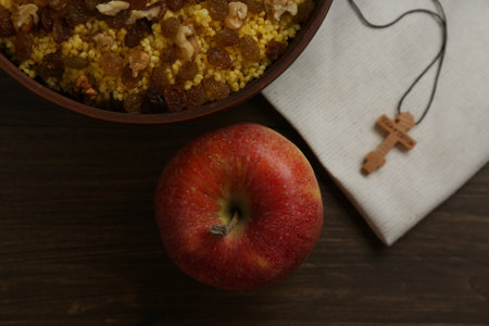 Flat lay composition with Great Lent dinner and crucifix on wooden tableの写真素材
