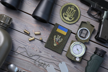 MYKOLAIV, UKRAINE - SEPTEMBER 19, 2020: Flat lay composition with Ukraine military equipment on gray wooden tableのeditorial素材