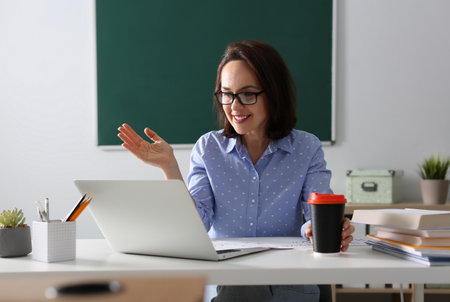 Teacher conducting online lesson in classroom during pandemicの写真素材
