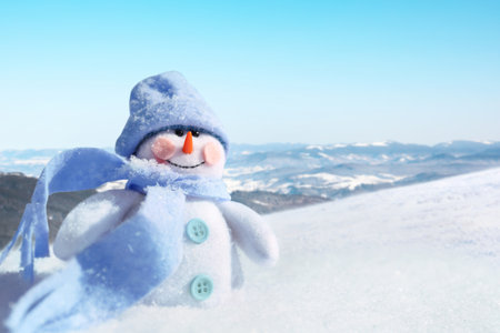 Cute small decorative snowman outdoors on sunny day, space for textの写真素材