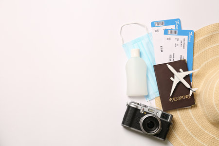 Composition with passport and protective mask on white background, top view. Travel during quarantineの写真素材
