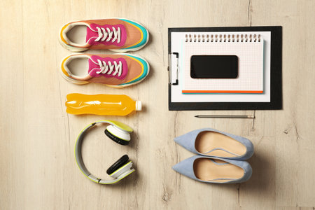 Flat lay composition with business items and sport accessories on wooden background. Concept of...
