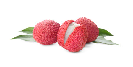 Fresh ripe lychees with green leaves on white backgroundの写真素材