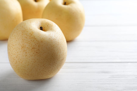 Ripe apple pear on white wooden table. Space for textの写真素材