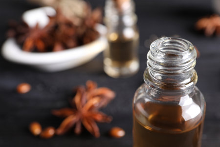 Anise essential oil in bottle on table, closeup. Space for textの写真素材