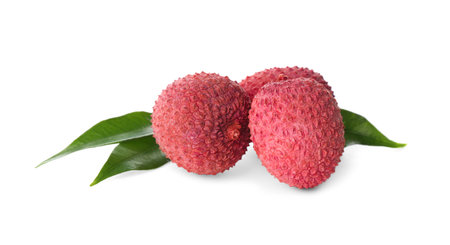 Fresh ripe lychees with green leaves on white backgroundの写真素材