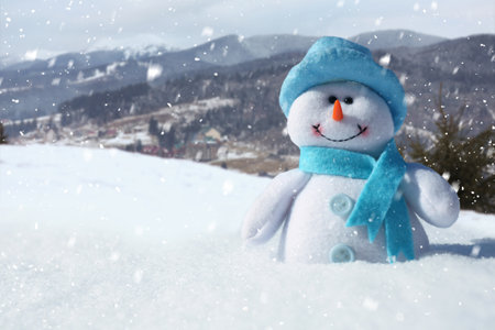Cute small decorative snowman outdoors on sunny day, space for textの写真素材