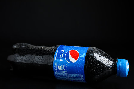 MYKOLAIV, UKRAINE - FEBRUARY 08, 2021: Plastic bottle of Pepsi with water drops on black backgroundのeditorial素材