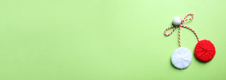 Traditional martisor on green background, top view with space for text. Beginning of spring celebrationの写真素材