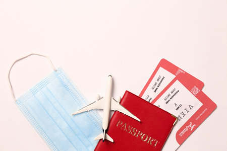 Composition with passport and protective mask on white background, top view. Travel during quarantineの写真素材