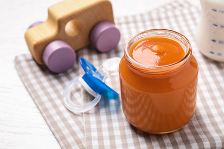 Healthy baby food in jar on table, closeup. Space for textの写真素材