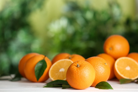 Fresh ripe oranges on white table against blurred background. Space for textの写真素材