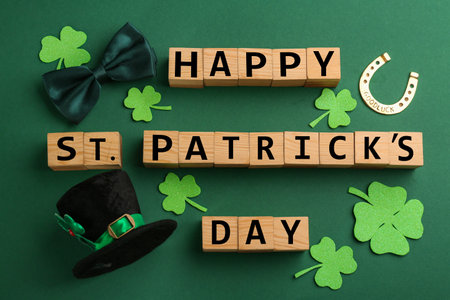 Words Happy St. Patrick's day and festive decor on green background, flat layの写真素材