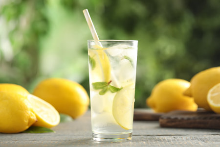 Cool freshly made lemonade and fruits on gray wooden tableの写真素材