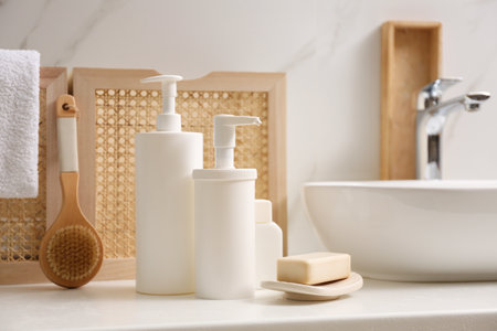Toiletries and personal hygiene products on white countertop in bathroomの写真素材