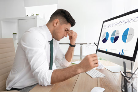 Businessman stressing out at workplace in officeの写真素材