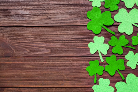 Flat lay composition with clover leaves on wooden background, space for text. St. Patrick's Day celebrationの写真素材