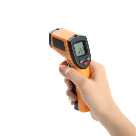 Woman with infrared thermometer on white background, closeup. Checking temperature during Covid-19...