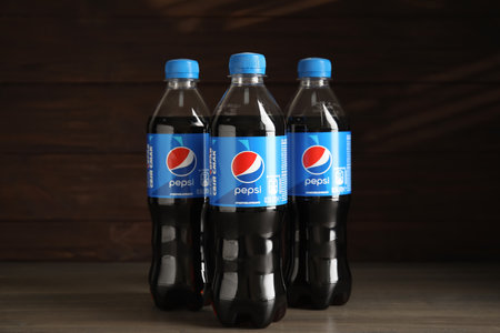 MYKOLAIV, UKRAINE - FEBRUARY 9, 2021: Many bottles of Pepsi on wooden tableのeditorial素材