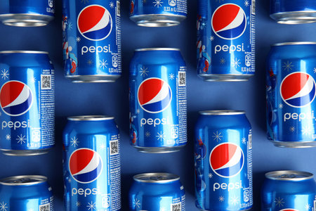 MYKOLAIV, UKRAINE - FEBRUARY 08, 2021: Cans of Pepsi on blue background, flat layのeditorial素材