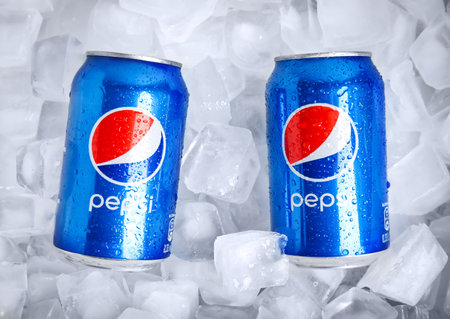 MYKOLAIV, UKRAINE - FEBRUARY 11, 2021: Cans of Pepsi on ice cubes, flat lay