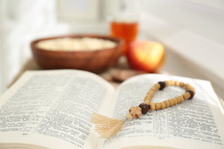 Holy Bible with prayer beads on window sill indoors, closeup. Great Lent seasonの写真素材