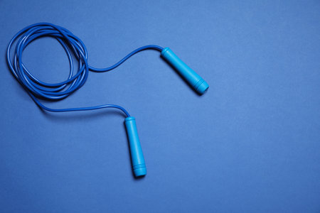 Skipping rope on blue background, top viewの写真素材