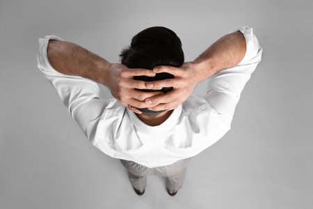 Businessman in formal clothes on gray background, back viewの写真素材