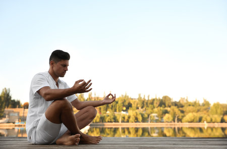 Man near river at sunset, space for text. nature healing powerの写真素材