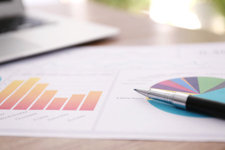 Paper document with charts and pen on table, closeup. investment analysisの写真素材