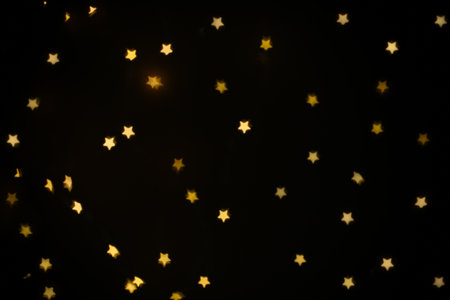 Beautiful star shaped lights on black backgroundの写真素材