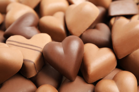 Tasty heart shaped chocolate candies as background, closeup. Valentine's day celebrationの写真素材