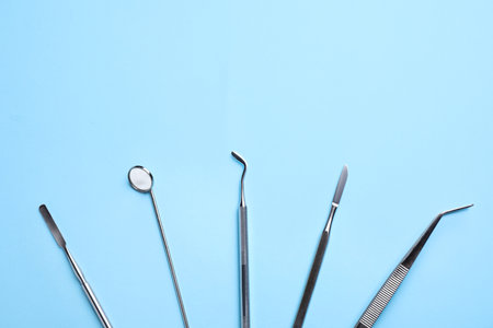 Set of different dentist tools on light blue background, flat lay. Space for textの写真素材