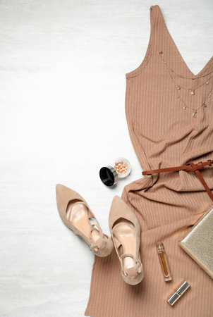 Flat lay composition with stylish shoes and new dress on white wooden backgroundの写真素材