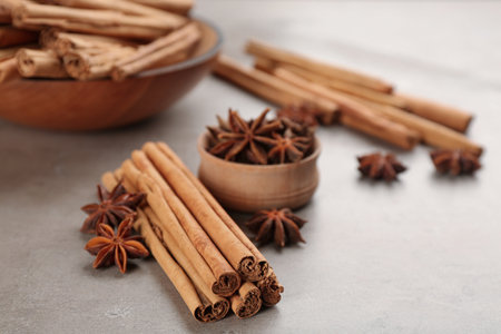Aromatic cinnamon sticks and anise on gray tableの写真素材