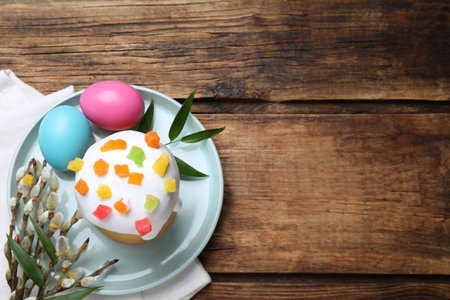 Easter cake and painted eggs on wooden table, flat lay. Space for textの写真素材