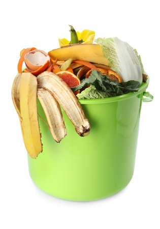 Trash bin with organic waste for composting on white backgroundの写真素材