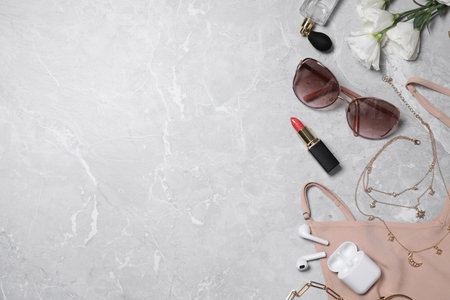 Flat lay composition with women's accessories on light grey marble background. Space for textの写真素材