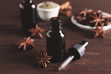 Anise essential oil and spice on wooden tableの写真素材