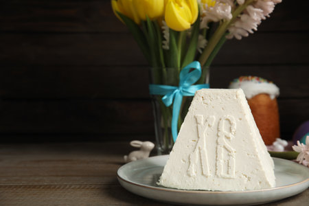 Traditional cottage cheese Easter paskha on wooden table, space for text