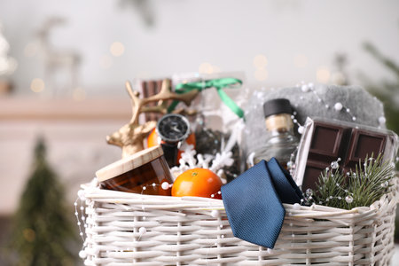 Wicker basket with Christmas gift set on blurred backgroundの写真素材