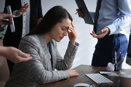 Businesswoman stressing out at workplace in officeの写真素材