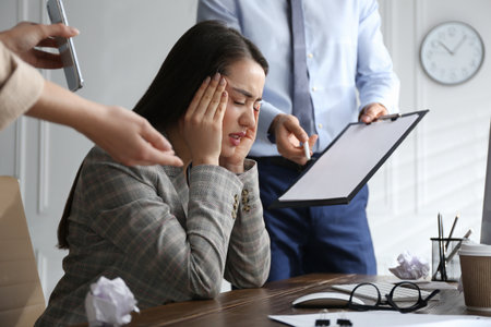 Businesswoman stressing out at workplace in officeの写真素材
