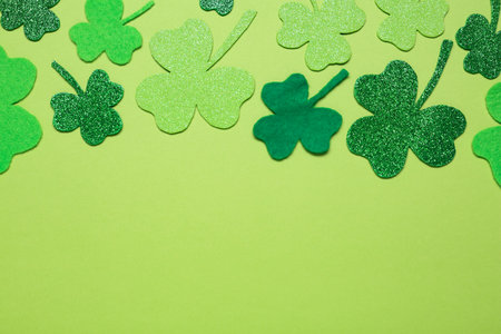 Flat lay composition with clover leaves on light green background, space for text. St. Patrick's Day celebrationの写真素材