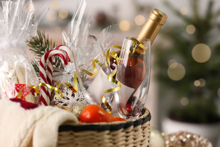 Wicker basket with Christmas gift set on blurred background, closeupの写真素材