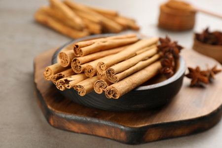 Aromatic cinnamon sticks and anise on grey table, closeupの写真素材