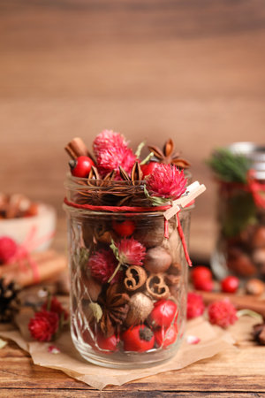 Aromatic potpourri in glass jar on wooden tableの写真素材