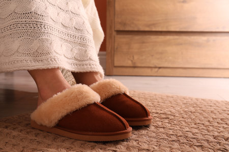Woman in warm soft slippers at home, closeupの写真素材