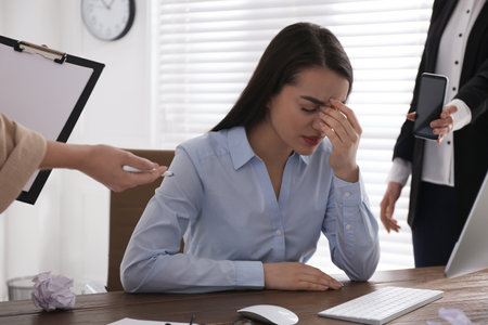 Businesswoman stressing out at workplace in officeの写真素材