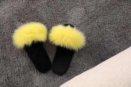 Yellow warm slippers on floor in room, flat layの写真素材